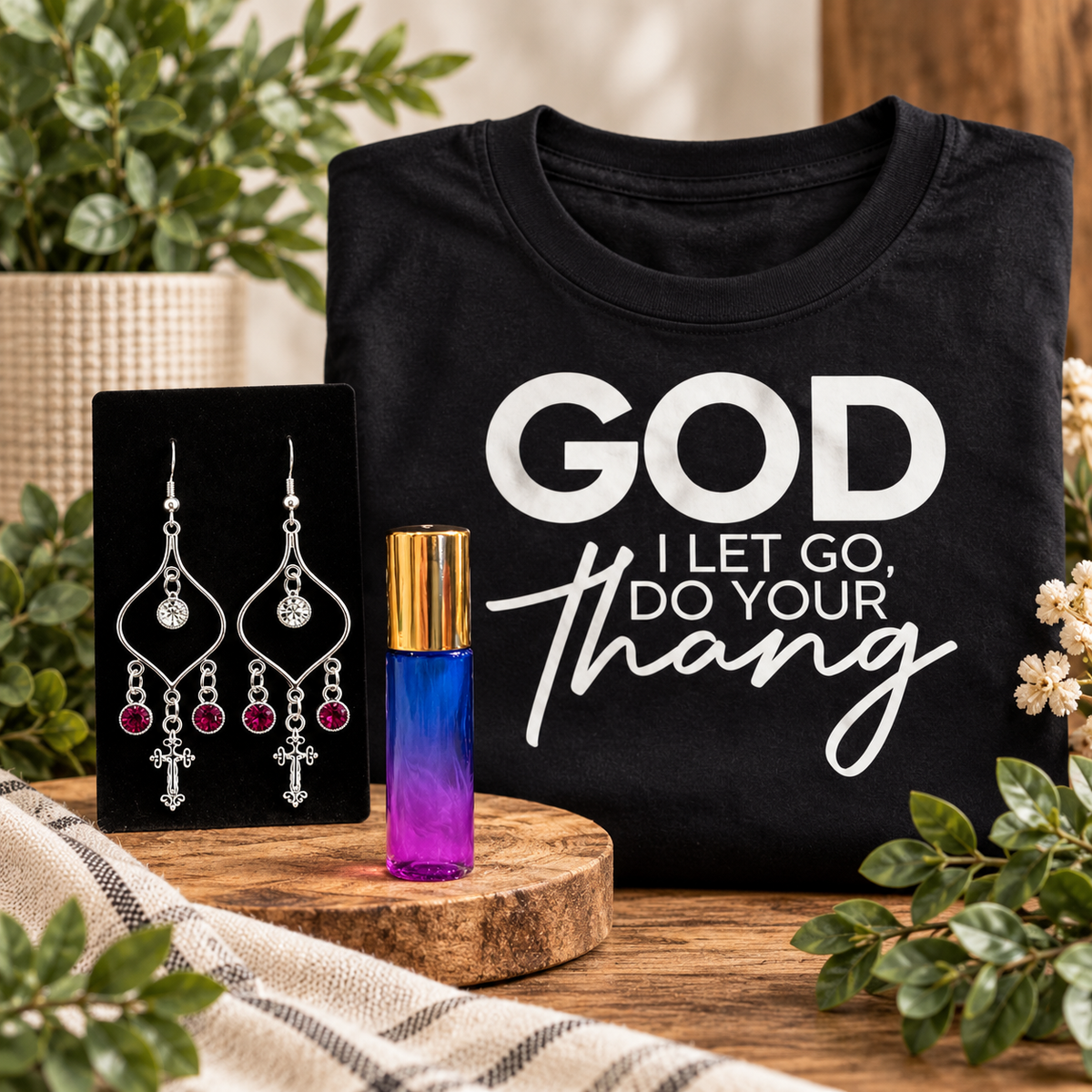 Decree Candle Co. faith-based goods featuring anointing oil, Christian cross earrings, and a faith-based graphic tee.