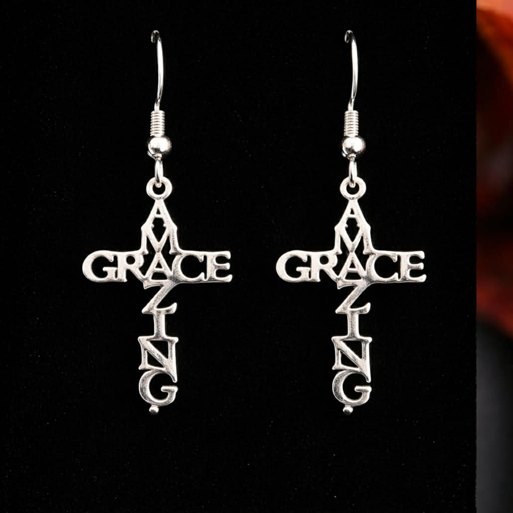 Amazing Grace cross earrings on black background
