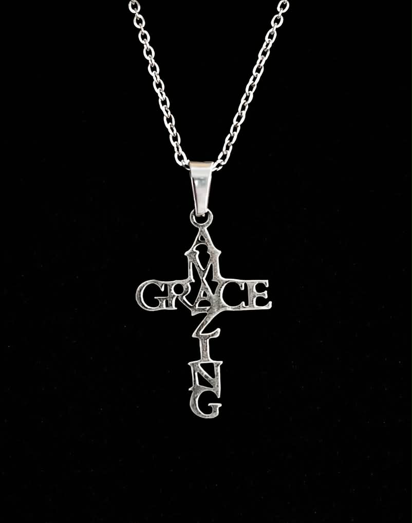 Amazing Grace cross necklace on black background