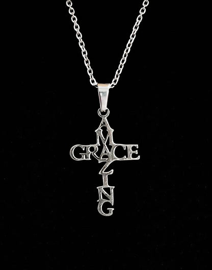 Amazing Grace cross necklace on black background