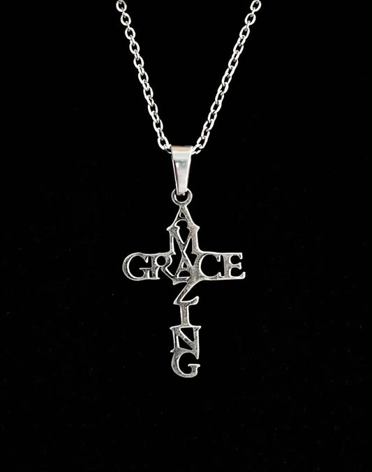 Amazing Grace cross necklace on black background