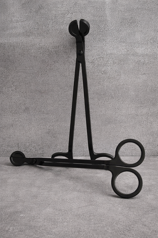 Black metal candle wick trimmer with angled handle and debris-catching tray