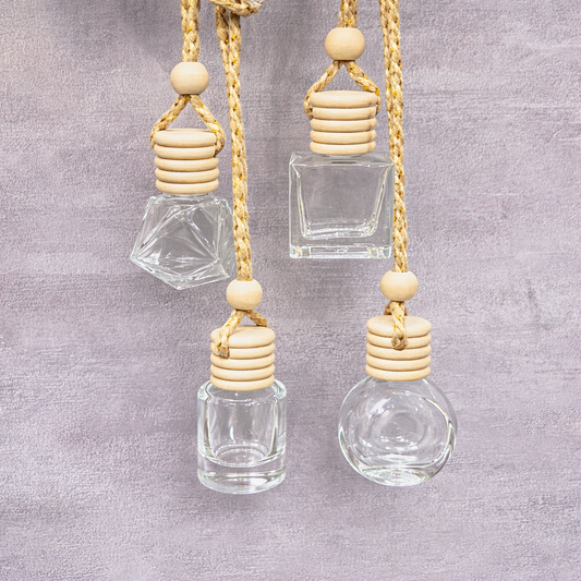 Hanging glass bottle diffusers by Decree Candle Co