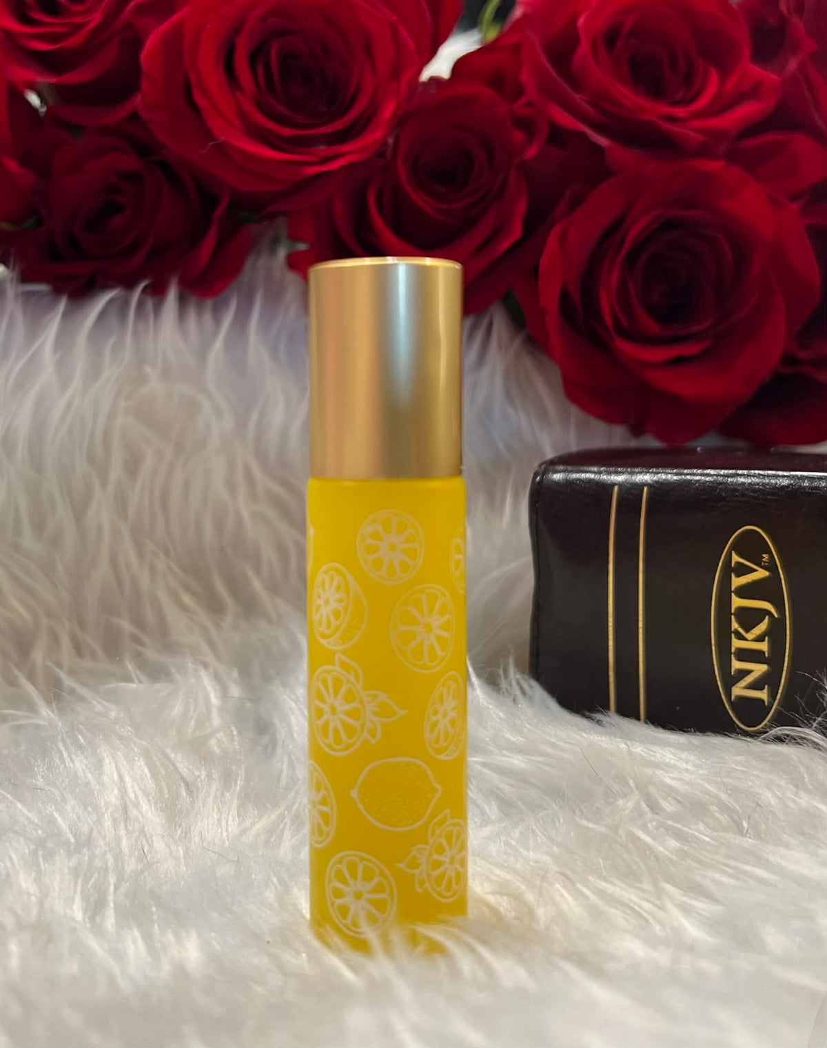 Lemon yellow glass anointing oil roller bottle with white decorative design